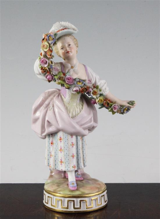 A Meissen figure of a lady holding a garland of flowers, late 19th century, 17cm
